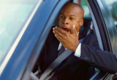 Man driving and yawning