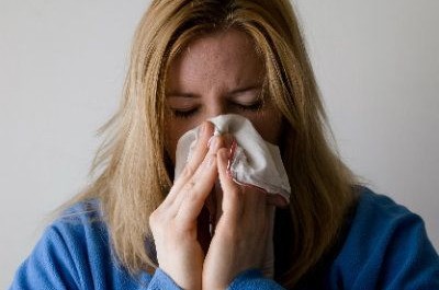 Woman blowing her nose