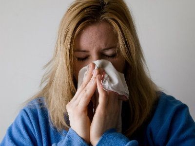 Woman blowing her nose