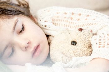 Sleeping child withteddy  bear